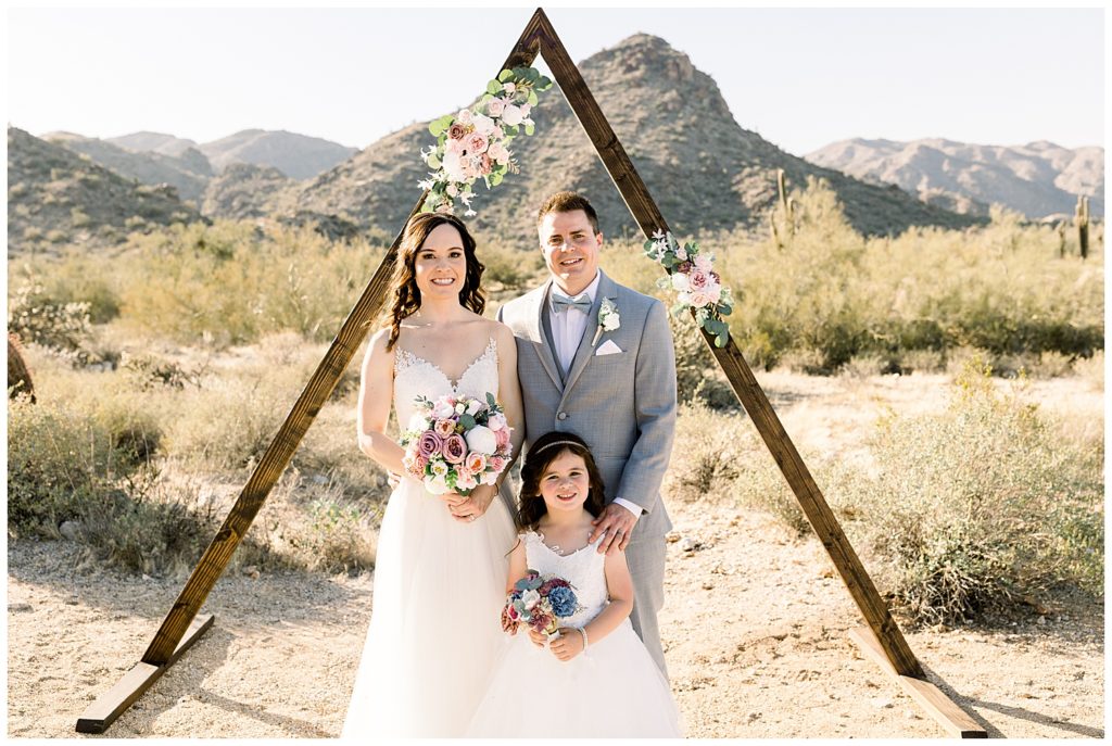 Desert Elopement in Arizona with Arch and florals, mountain views