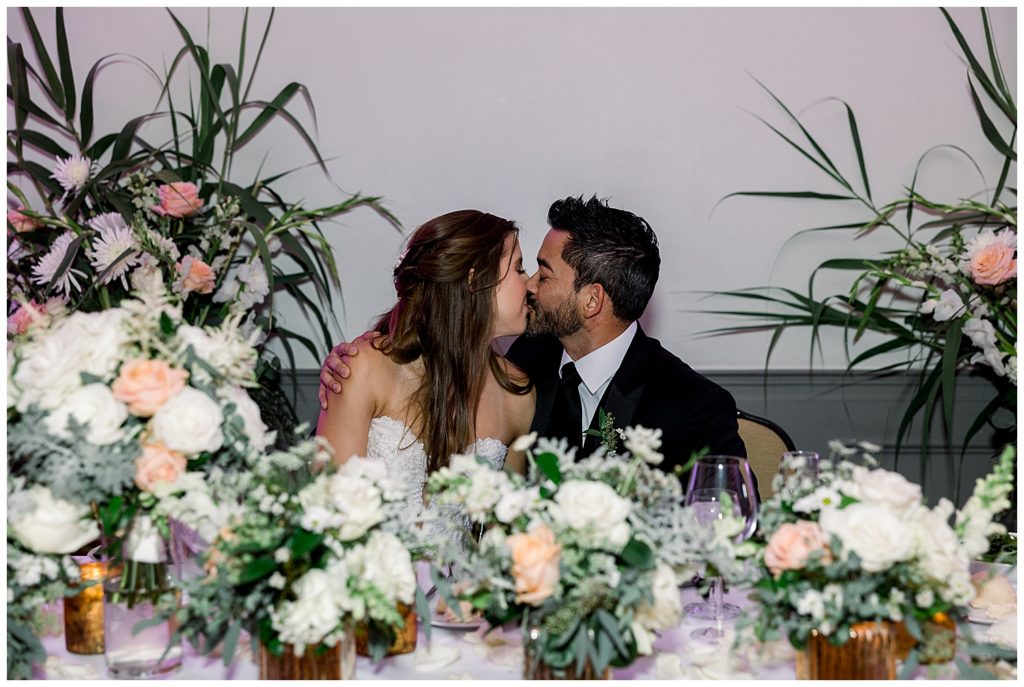 Sweetheart table kiss at Mr and Mrs at L'Auberge de Sedona